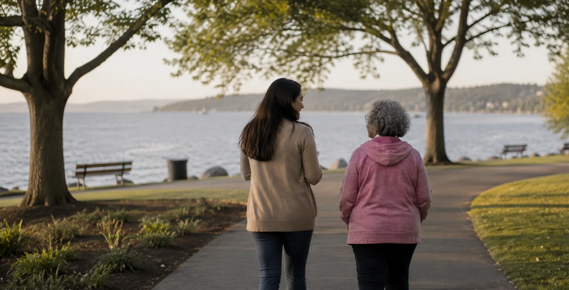 Care coordinator walking with client along waterfront path in Washington State
